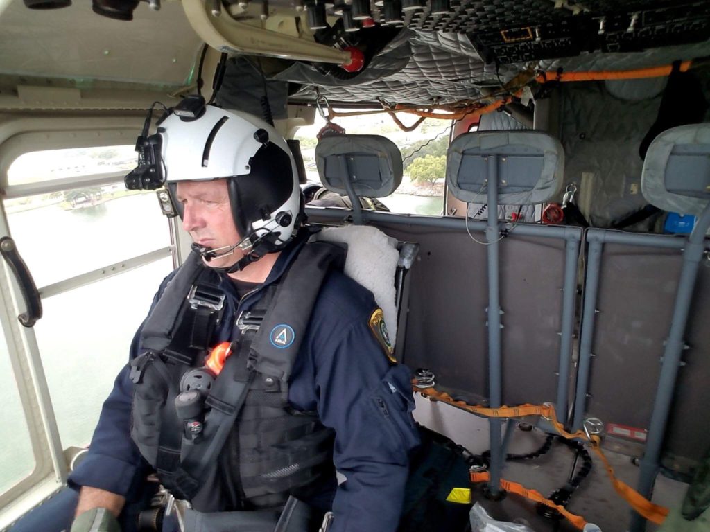 Houston helicopter pilot prepares for flight inside aircraft cockpit during safety mission