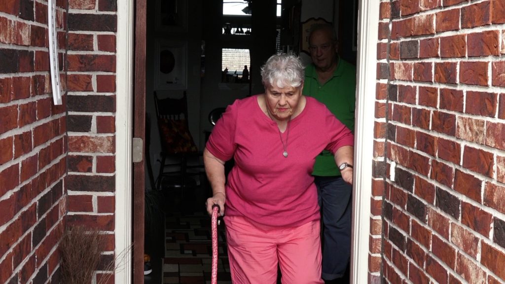 Texas elderly homeowner Dorothy Tadema walks outside her home during HOA dispute over flower beds and $100,000 lien investigated by journalist Tammy Rose