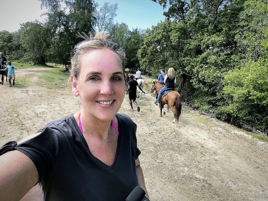 Tammy Rose riding a horse through the jungles of Honduras