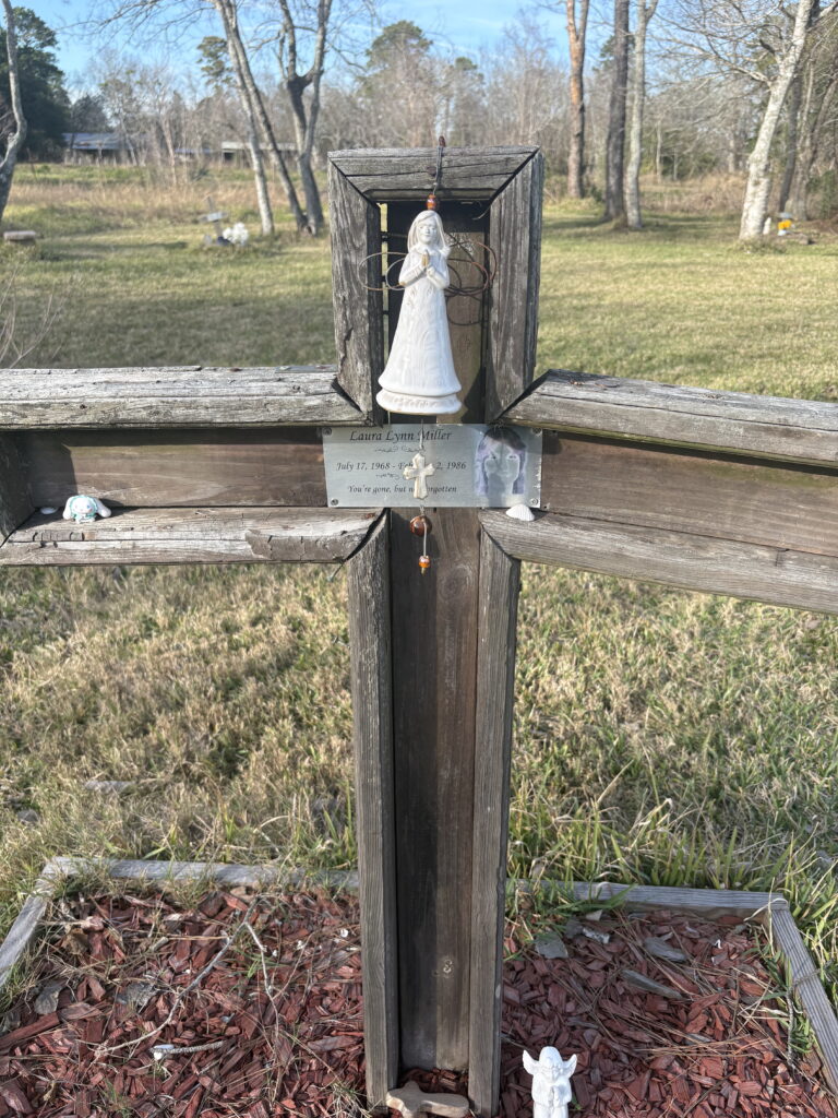 Cross memorial for Laura Miller near the Calder Road site in League City.