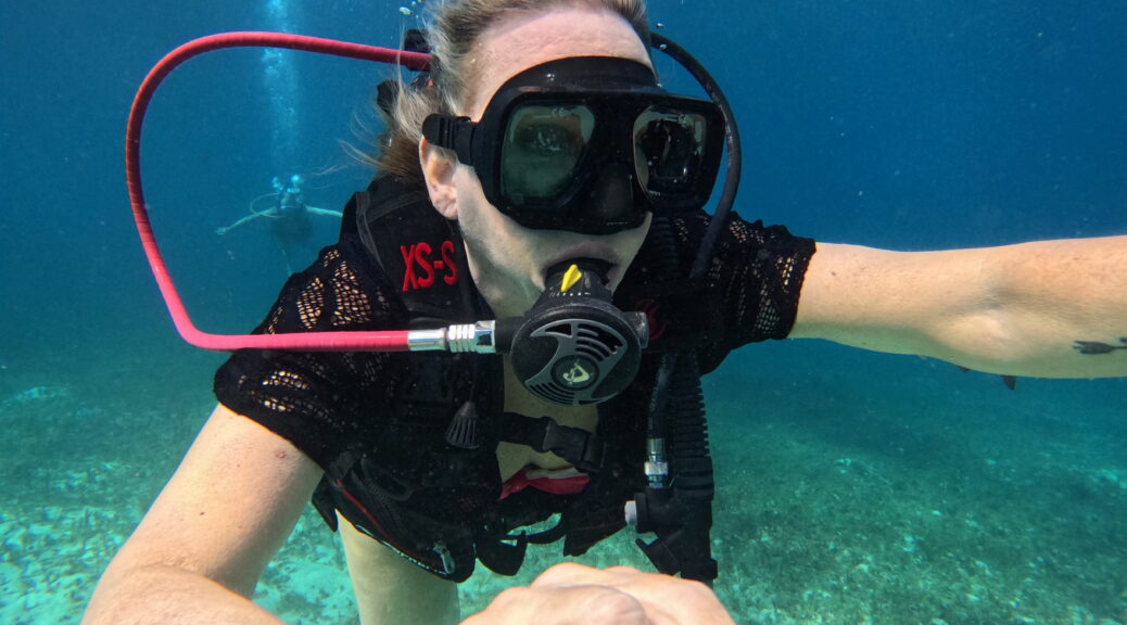 First-time diver exploring colorful underwater marine life at Chankanaab Beach, Cozumel