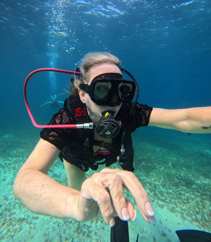 First-time diver underwater with scuba gear at Chankanaab Beach Cozumel