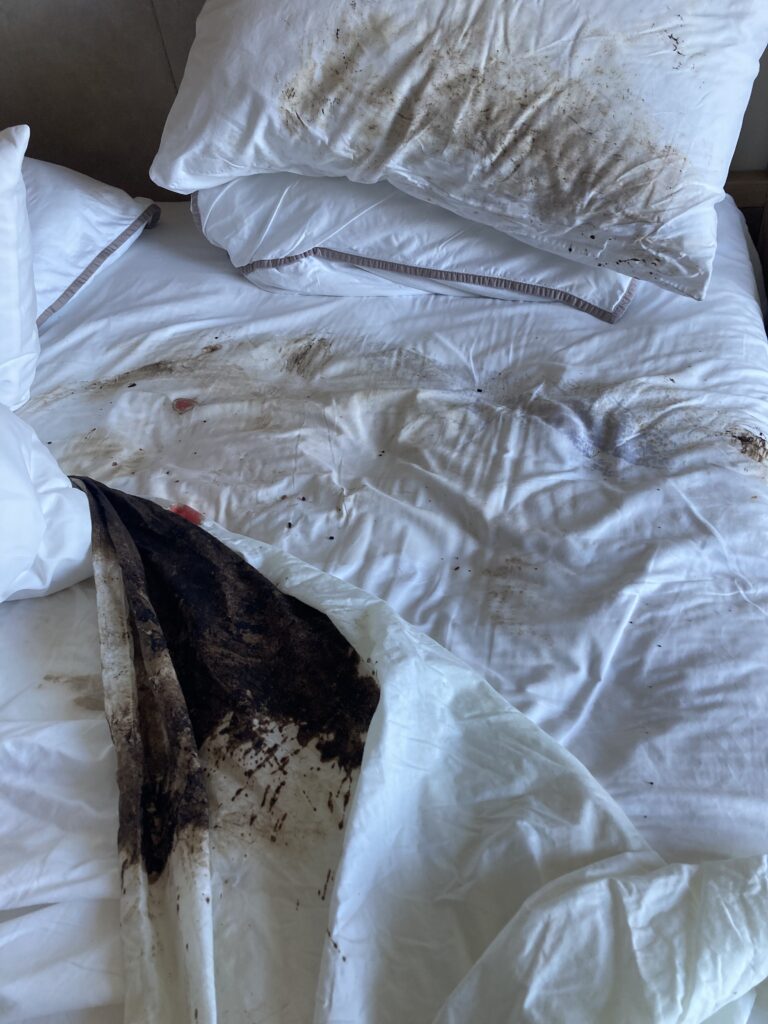 hotel bed with blood and vomit after Tammy Rose became sick from cenote water in Cozumel Mexico
