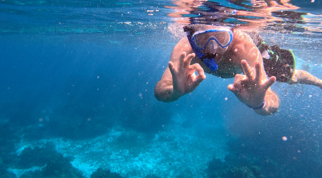 man snorkeling under water