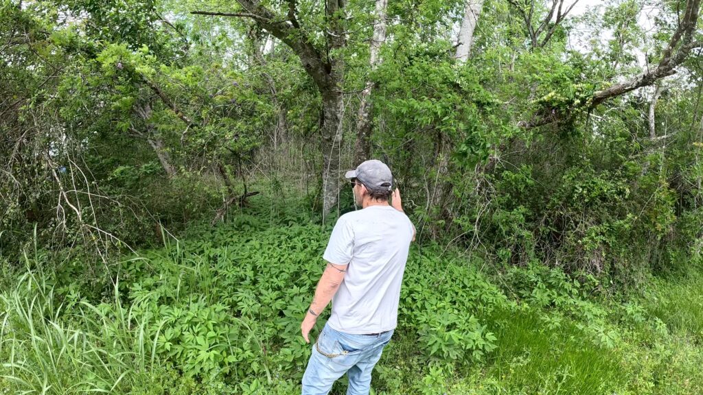 Former neighbor of Clyde Hedrick points to where he thinks the Texas Killing Field suspect lived in a trailer in Hitchcock.