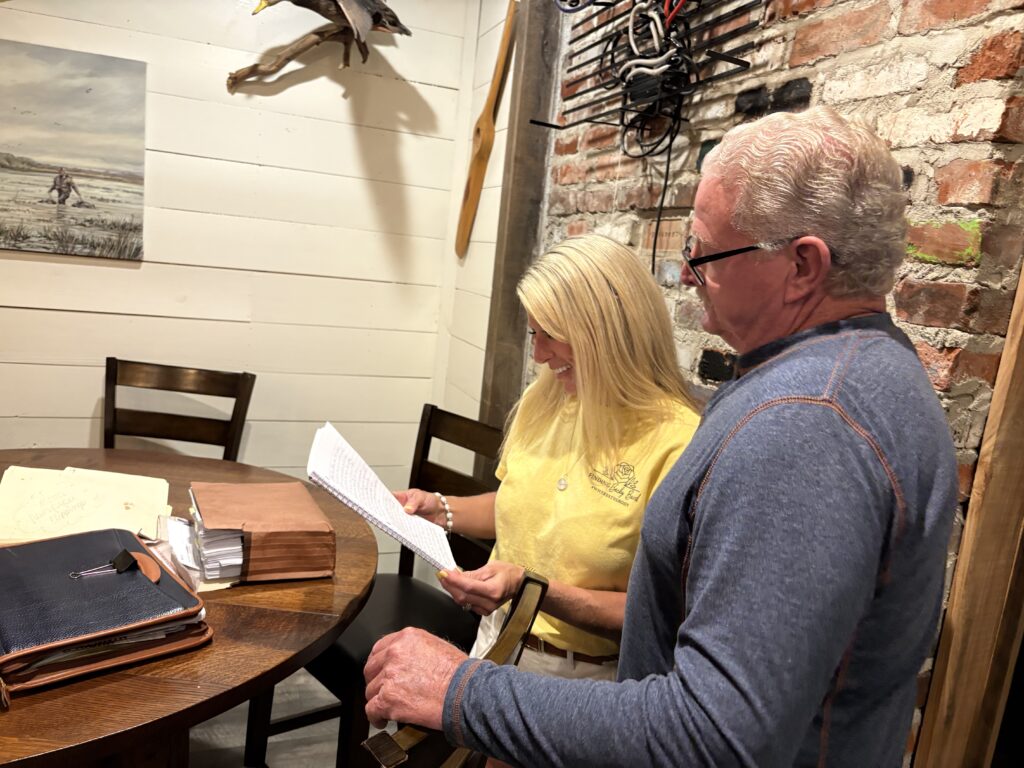 Brittany Pipkin and her father, Darrell Beard, review family records and memories of Rebecca Beard during an interview about the unsolved case.