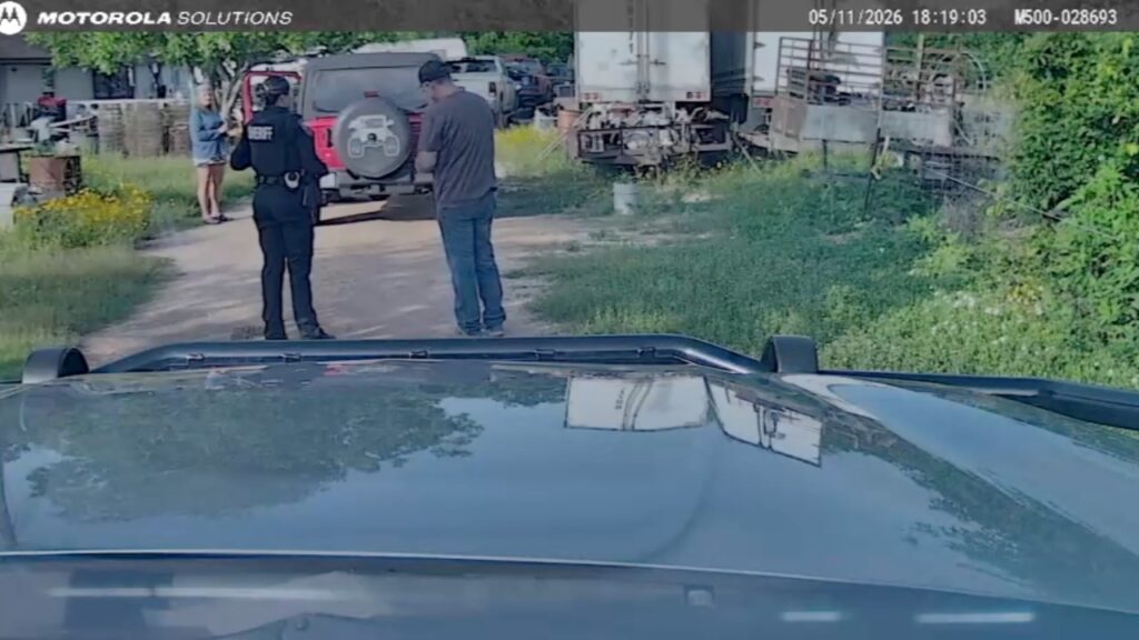 Raw dash camera image released through a Texas Public Information Act request showing a Brazoria County sheriff’s deputy speaking with individuals during a May 11, 2026 encounter related to the Rebecca Beard investigation.
