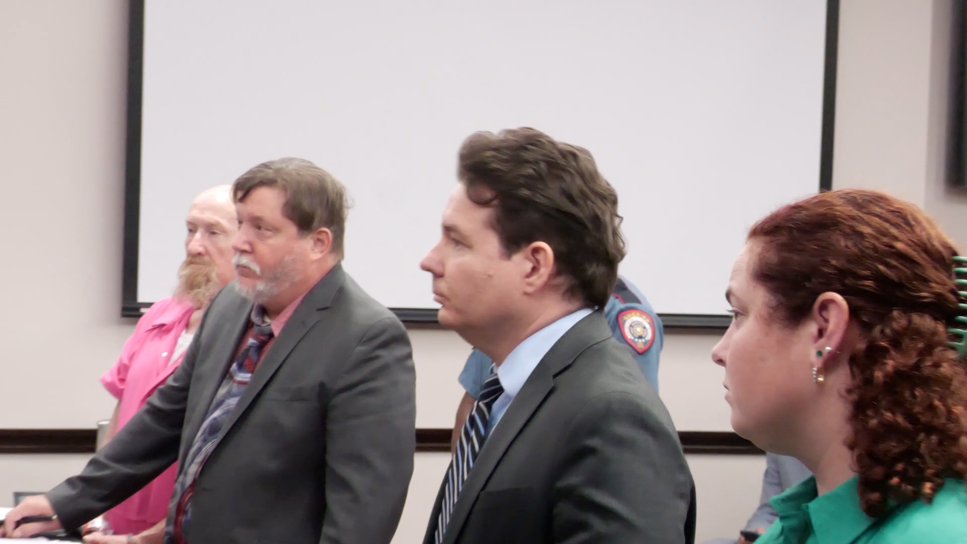 James Elmore Jr. stands with attorneys during a pretrial hearing in Galveston County ahead of his Aug. 31 manslaughter trial.