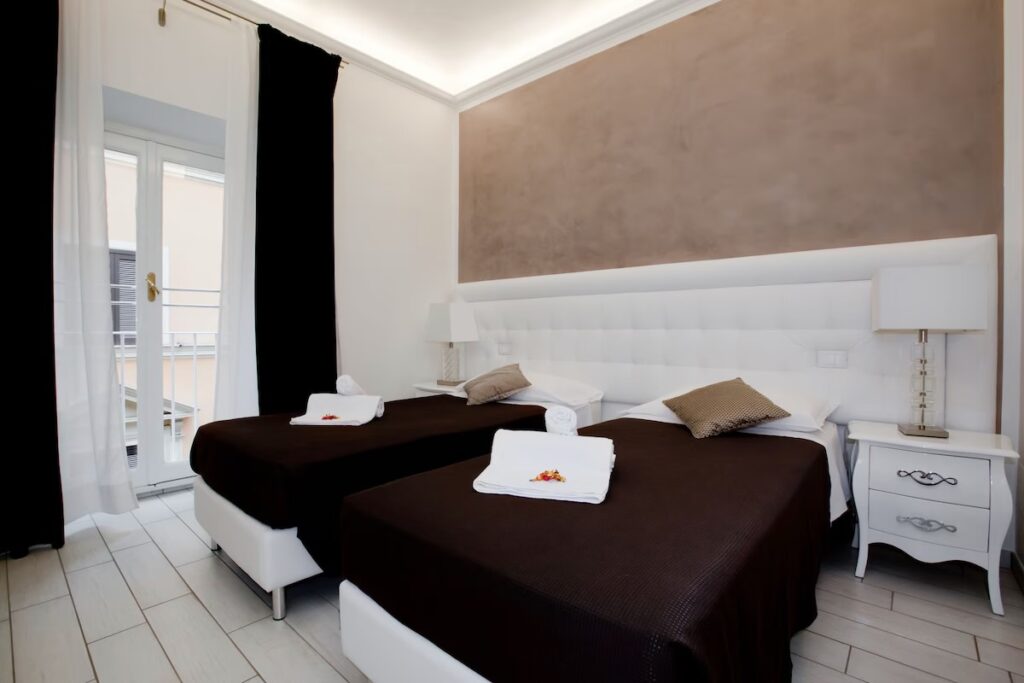Guest room at Town House Fontana di Trevi in Rome, Italy, featuring a double bed and bright modern interior.