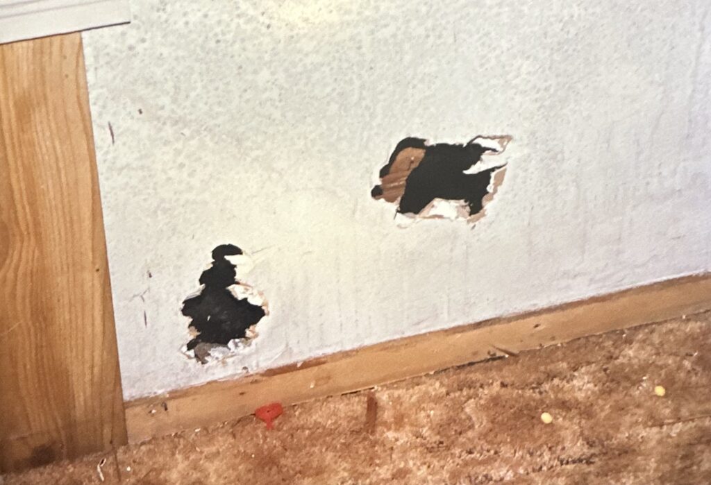 Crime scene photograph showing two suspected bullet holes inside the Clute home linked to Becky Beard’s murder.