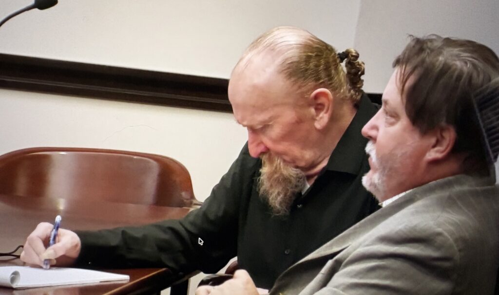 James Elmore Jr. sits with his defense attorney in a Galveston County courtroom during his trial.