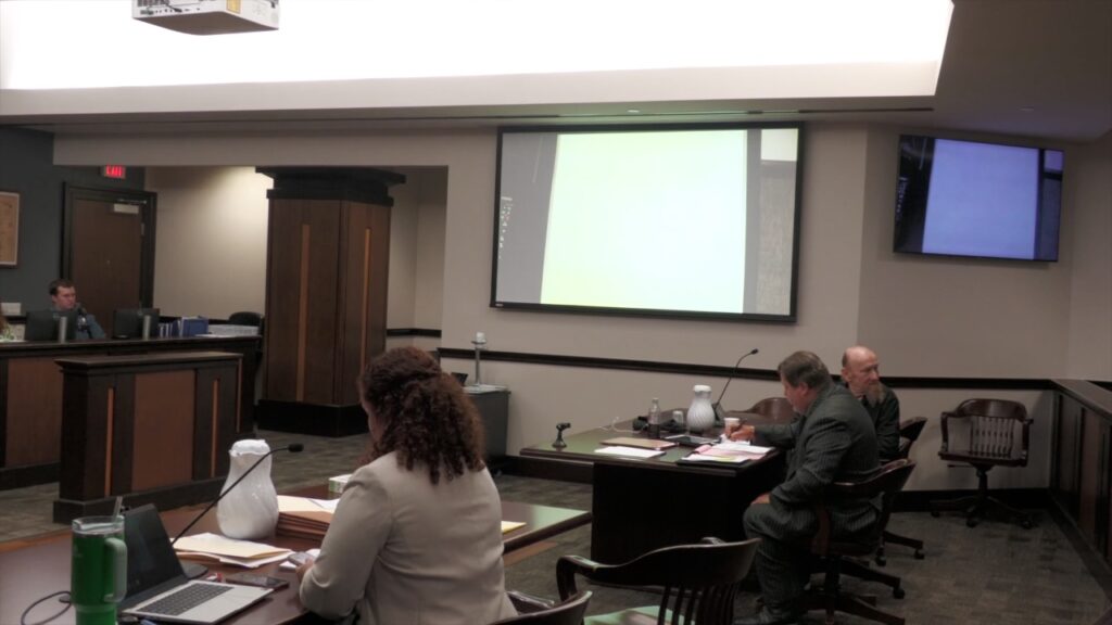James Elmore Jr. sits with his defense team during testimony in his Galveston County trial.