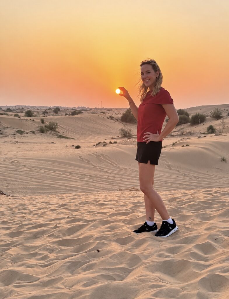  Investigative Reporter Tammy Rose enjoying a sunset in the Dubai desert during a safari excursion.