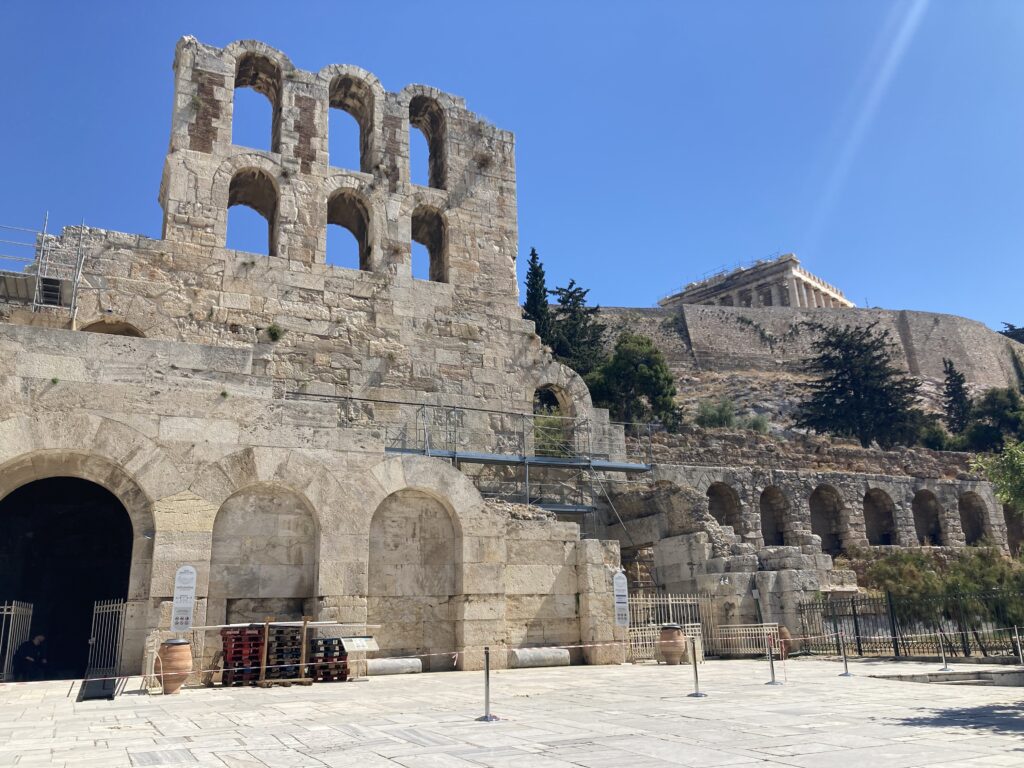 Ancient Odeon of Herodes Atticus and the Acropolis in Athens, Greece, during my trip when I contracted COVID-19.